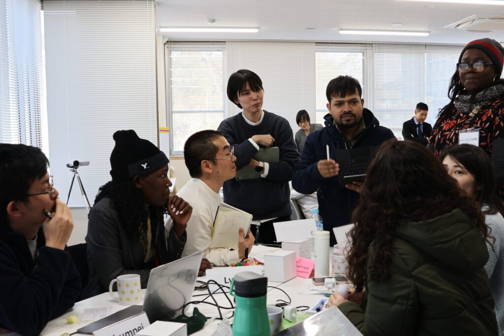 Mariya (fourth from the left) discussing with her peers